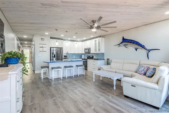 a kitchen with kitchen island a sink stove and refrigerator