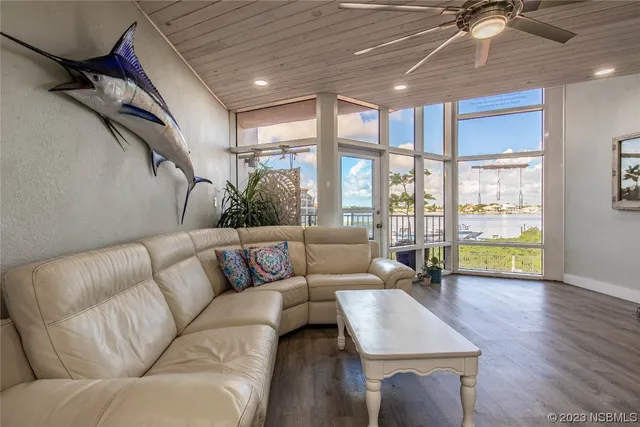 a bedroom with a large bed and a potted plant