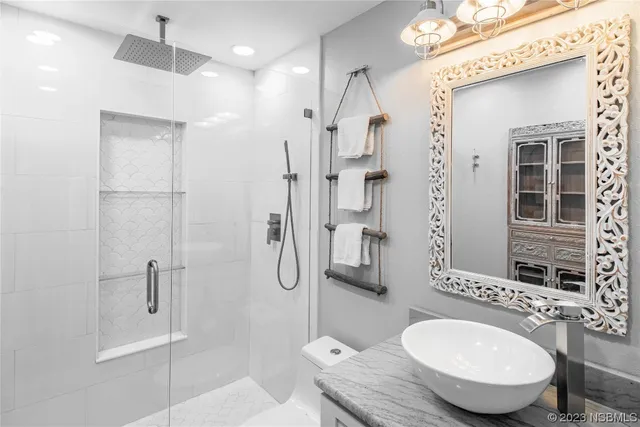 a bathroom with a toilet a sink and a mirror