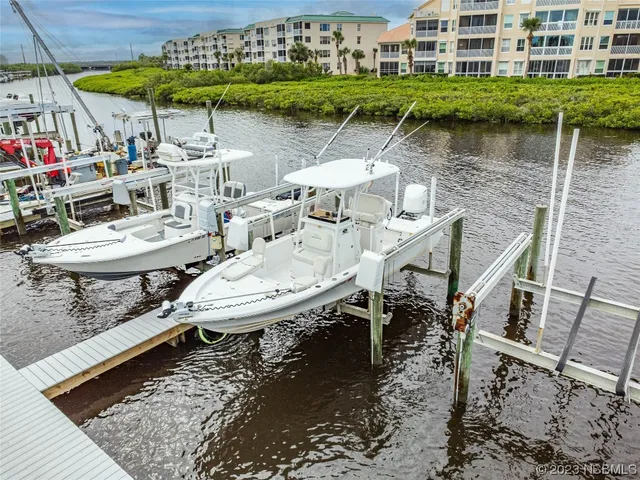 an aerial view of a house with swimming pool and outdoor seating