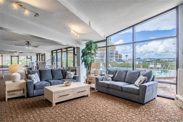 a room with pool table and windows