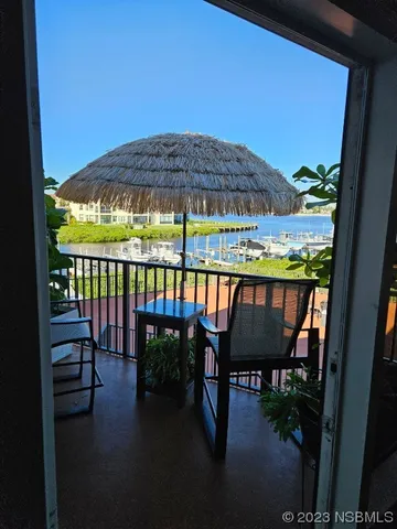 a view of a chairs and table in the balcony