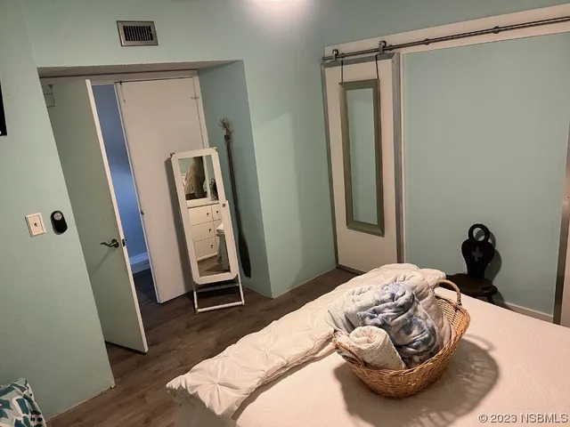 a bedroom with a bed and a mirror