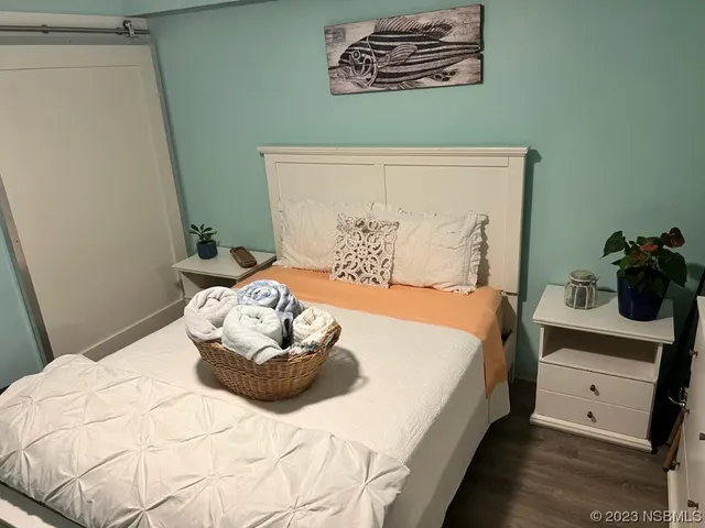 a bedroom with a bed and a potted plant