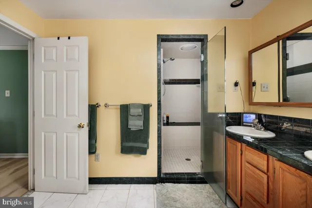 a front view of a house with a garden and trees