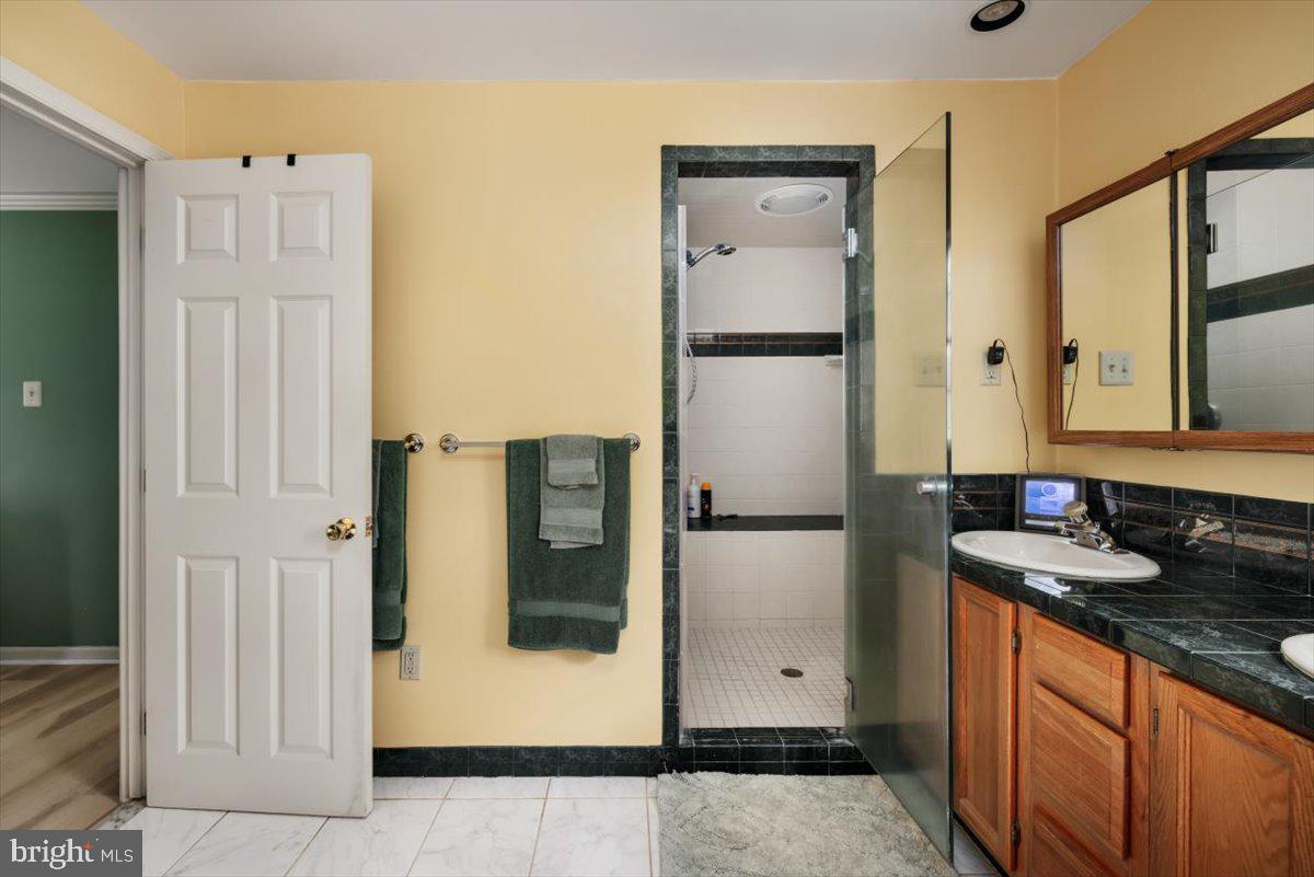 19606 Ridgeside Road Bluemont, VA 20135 - Photo 37 of 81 a kitchen with stainless steel appliances granite countertop a refrigerator and a sink