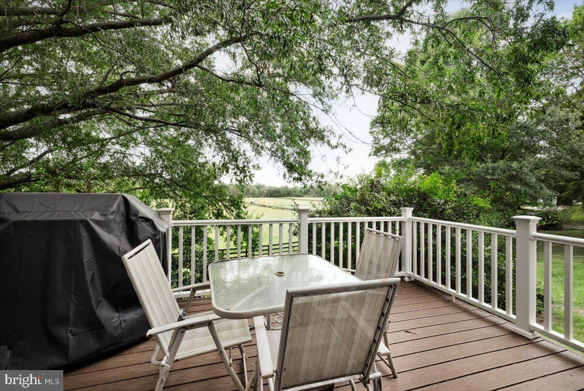 19606 Ridgeside Road Bluemont, VA 20135 - Photo 52 of 81 a balcony with wooden floor stairs and wooden fence
