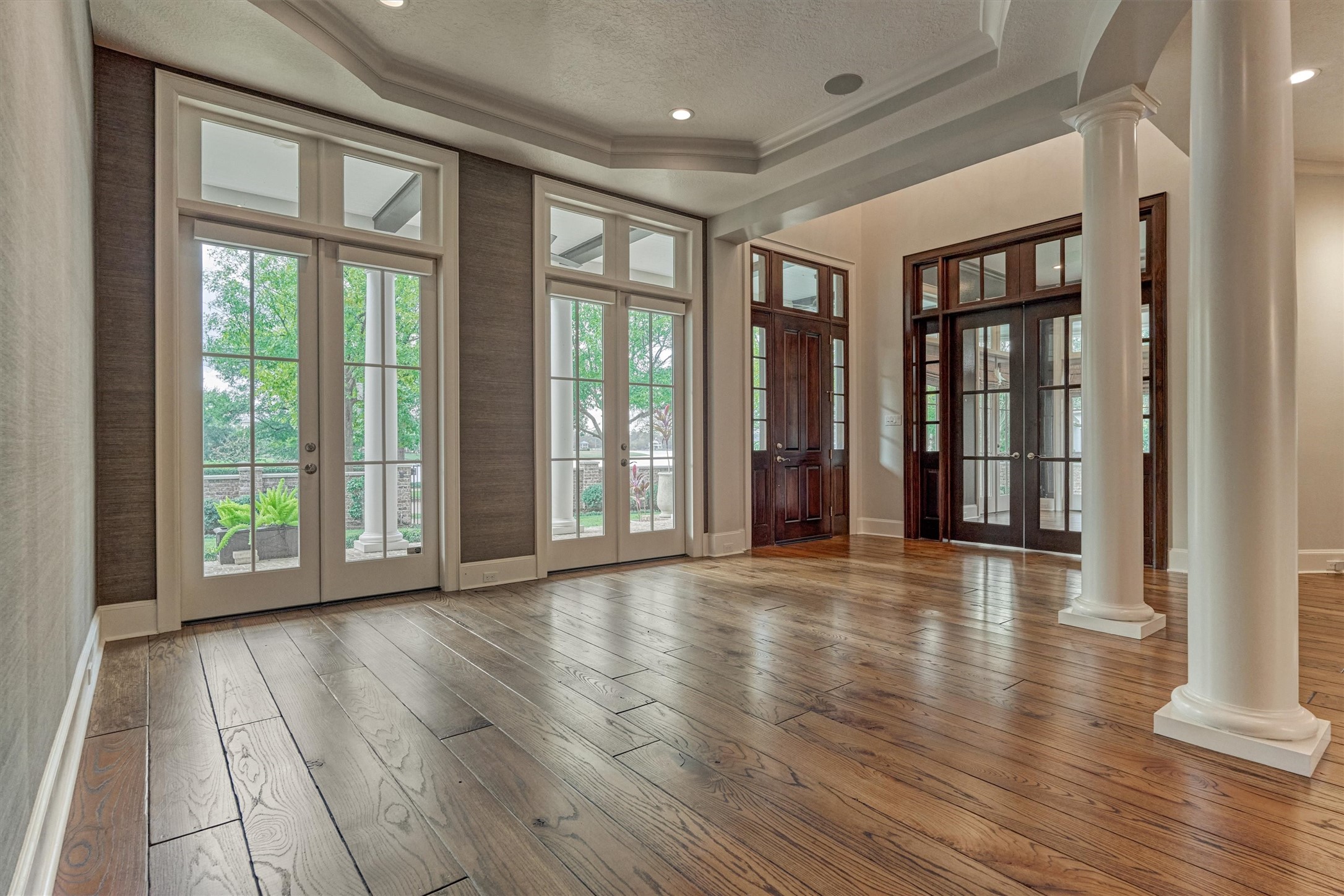 22 East Shore Drive The Woodlands, TX 77380 - Photo 7 of 50 Floor to ceiling windows surround the estate for views of the grounds and lake.