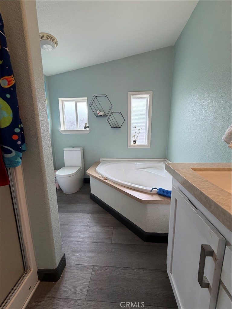 20401 Soledad Canyon Road, Unit 406 Canyon Country, CA 91351 - Photo 12 of 16 a spacious bathroom with a granite countertop toilet sink and mirror