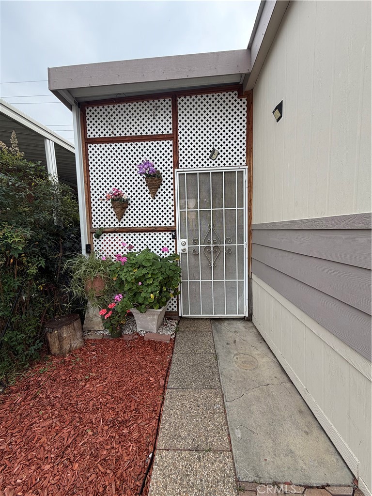 20401 Soledad Canyon Road, Unit 406 Canyon Country, CA 91351 - Photo 2 of 16 a front view of a house with a garden