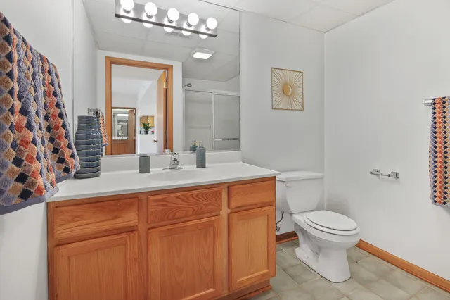 a bathroom with a sink a toilet and a mirror