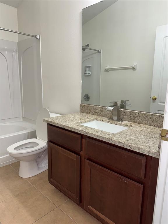 6404 South Goldenrod Road, Unit 2A Orlando, FL 32822 - Photo 16 of 40 a bathroom with a granite countertop toilet sink and mirror