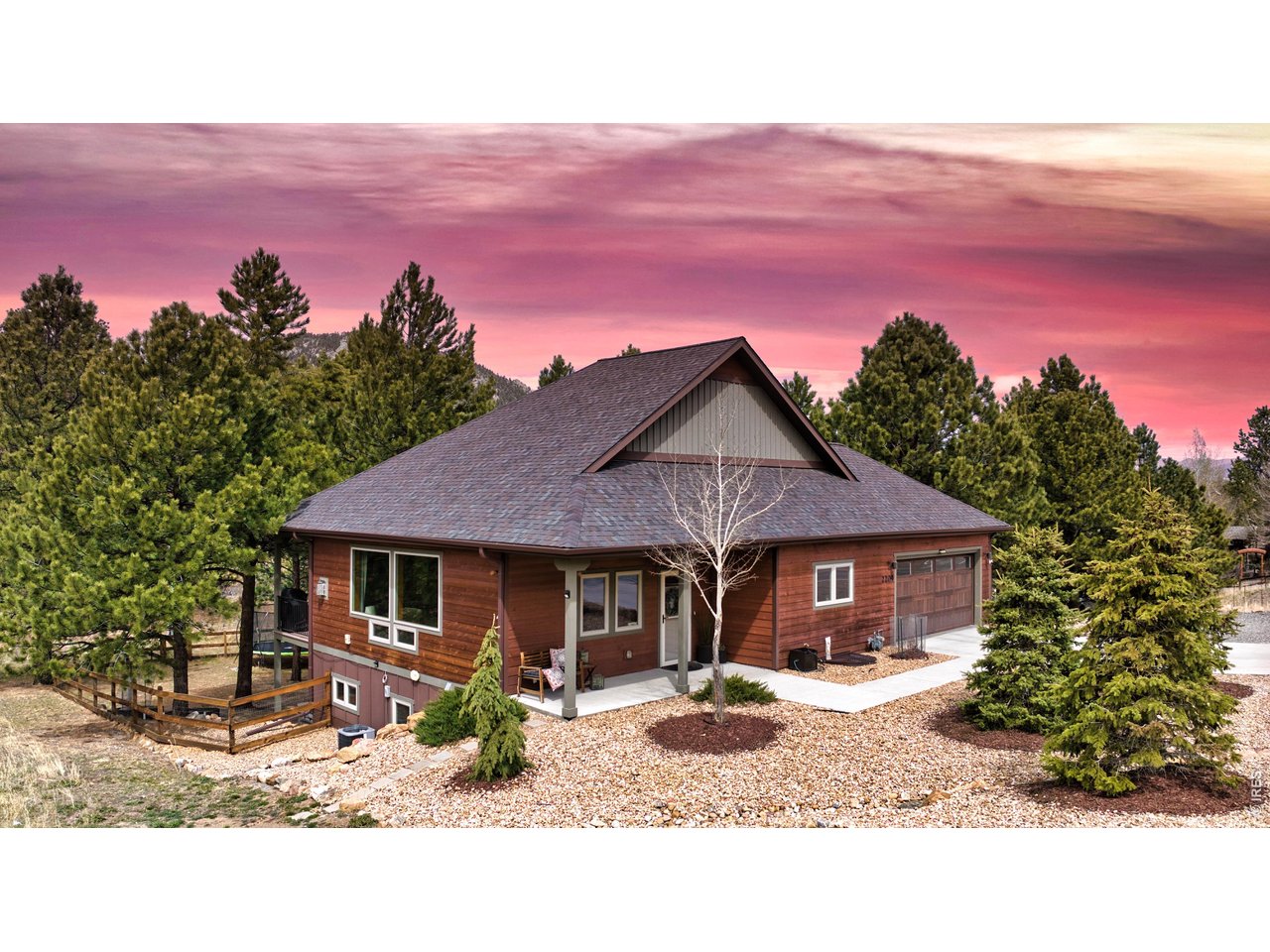 Sunset views highlight the modern exterior and professional landscape of the home.