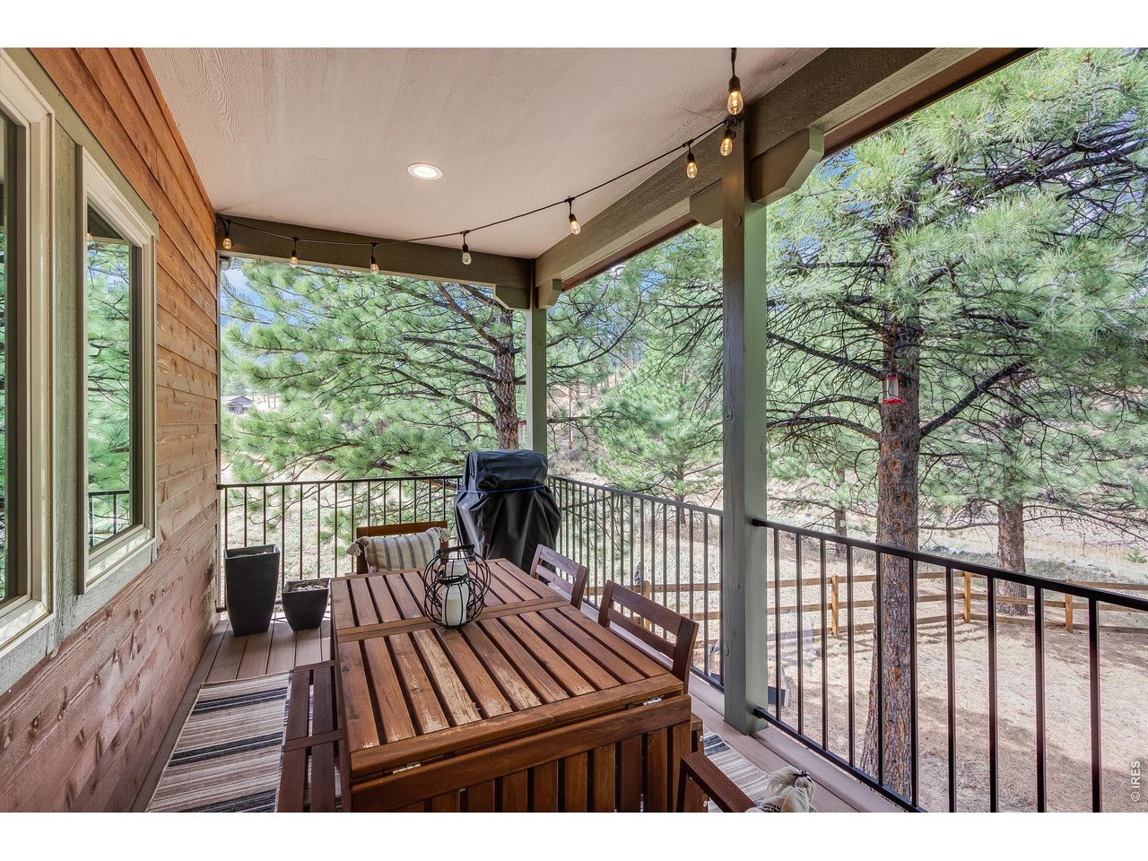 2209 Fish Creek Road Estes Park, CO 80517 - Photo 12 of 50 Enjoy your morning coffee on the covered deck while taking in the fresh mountain air.