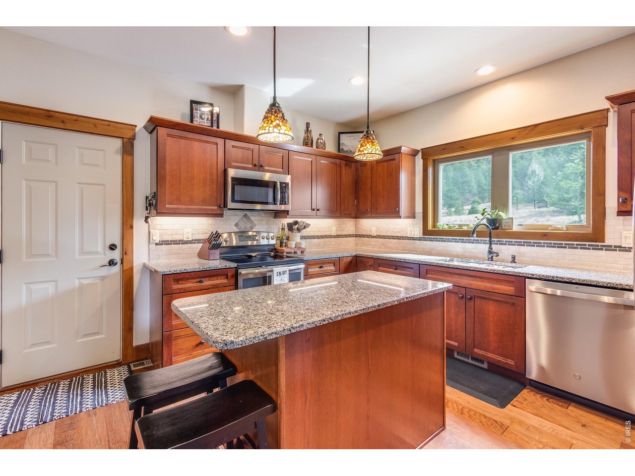 2209 Fish Creek Road Estes Park, CO 80517 - Photo 14 of 50 Modern kitchen featuring sleek stainless-steel appliances, stunning countertops, and ample custom cabinetry.