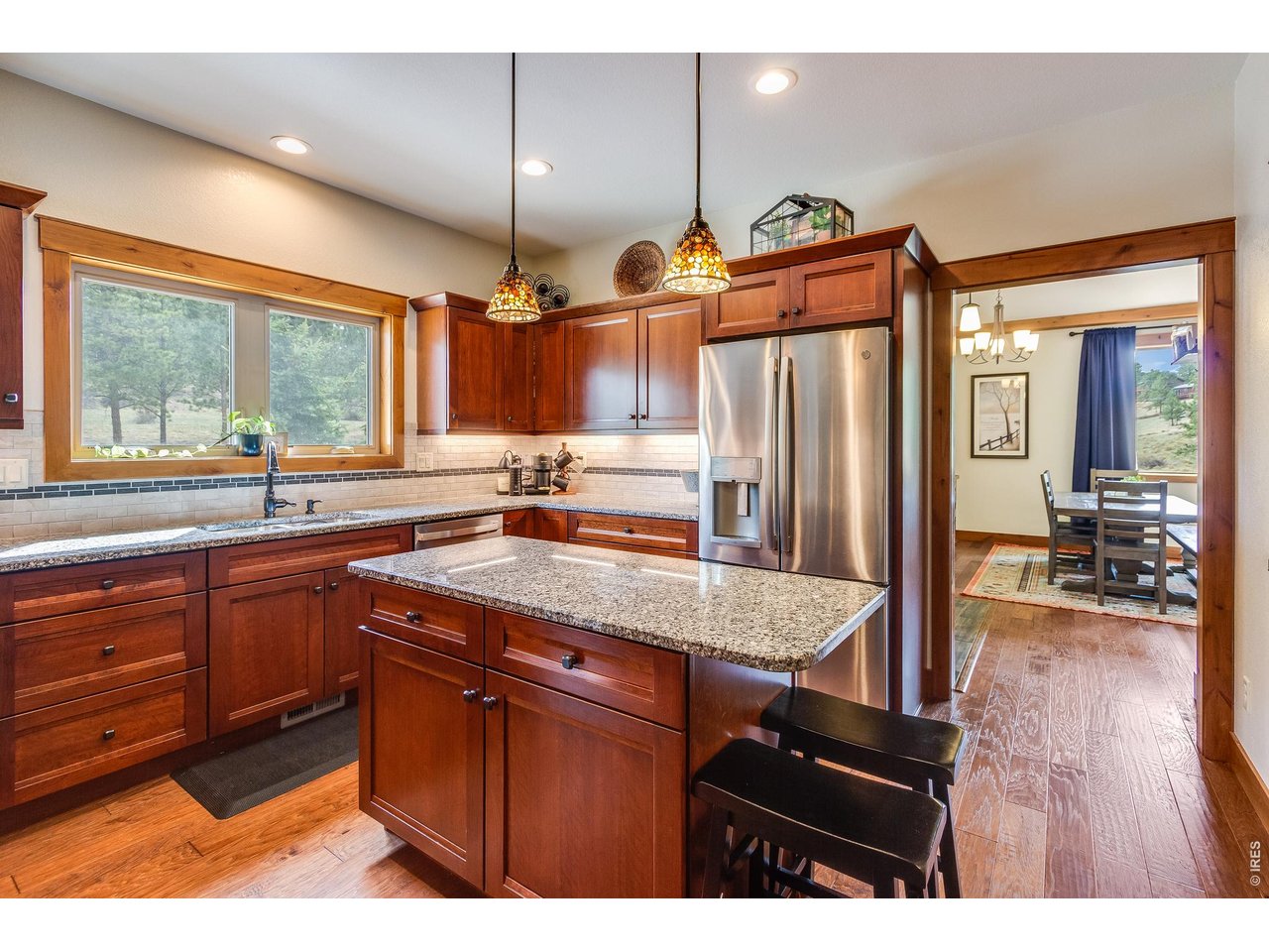 2209 Fish Creek Road Estes Park, CO 80517 - Photo 18 of 50 Bright and airy kitchen with custom cabinetry and seamless flow into the dining and living.