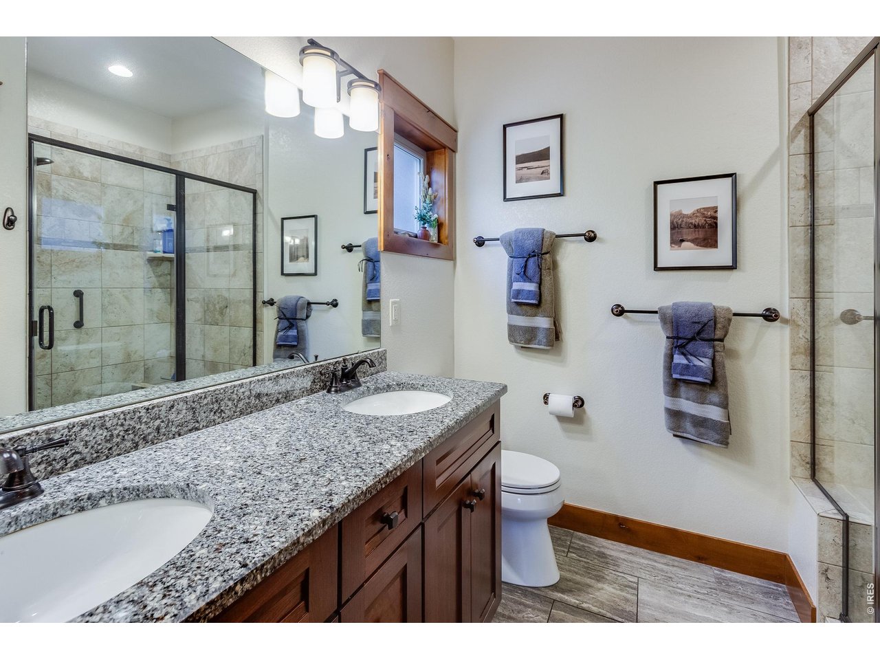 2209 Fish Creek Road Estes Park, CO 80517 - Photo 24 of 50 Spa-like primary bath with walk-in shower, and dual vanity sinks.