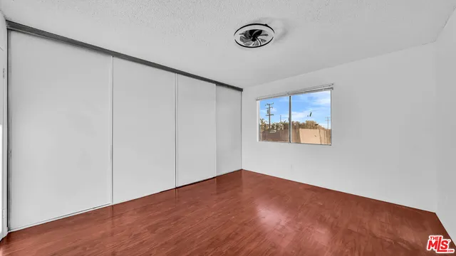 a view of a room with wooden floor