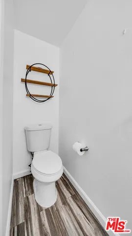 a bathroom with a toilet and a mirror