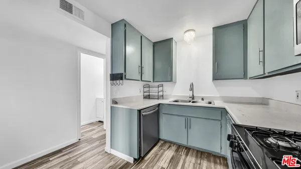 a kitchen with a sink and cabinets