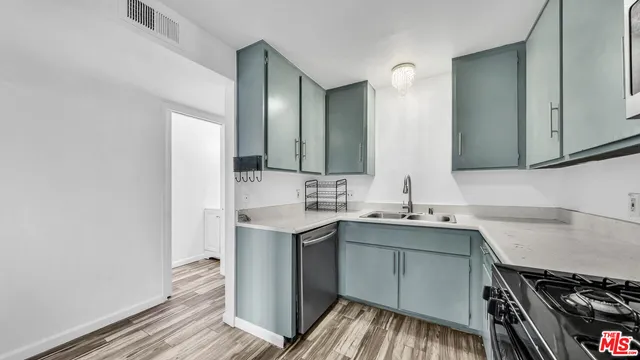 a kitchen with a sink and cabinets