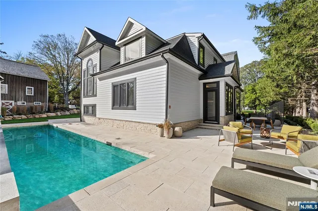 a view of a house with backyard sitting area and garden