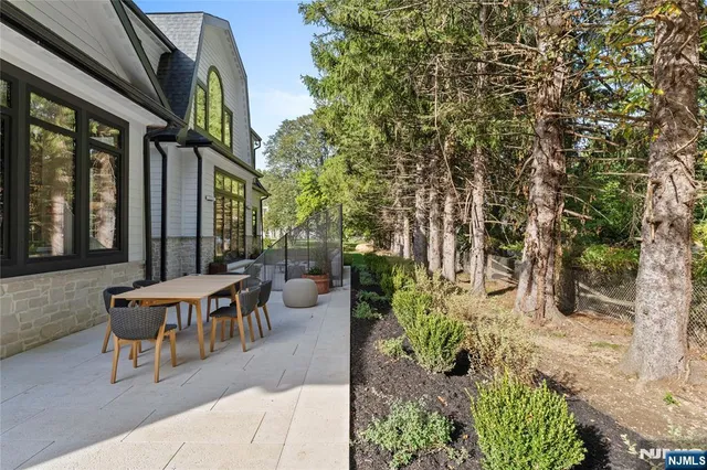 a view of a patio with table and chairs and potted plants