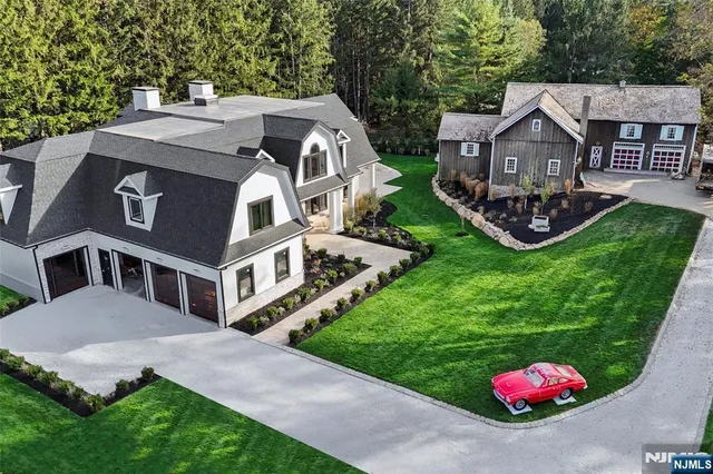 a aerial view of a house with swimming pool and a yard
