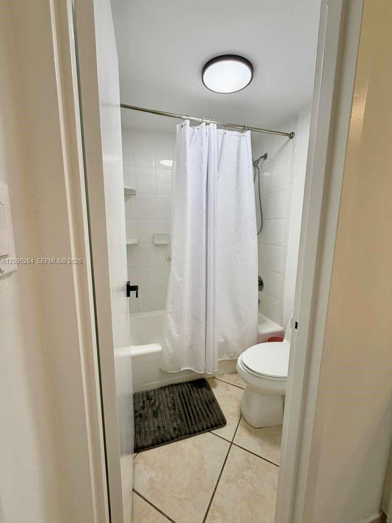 100 Lincoln Road, Unit 731 Miami Beach, FL 33139 - Photo 11 of 12 a bathroom with a granite countertop sink toilet and shower