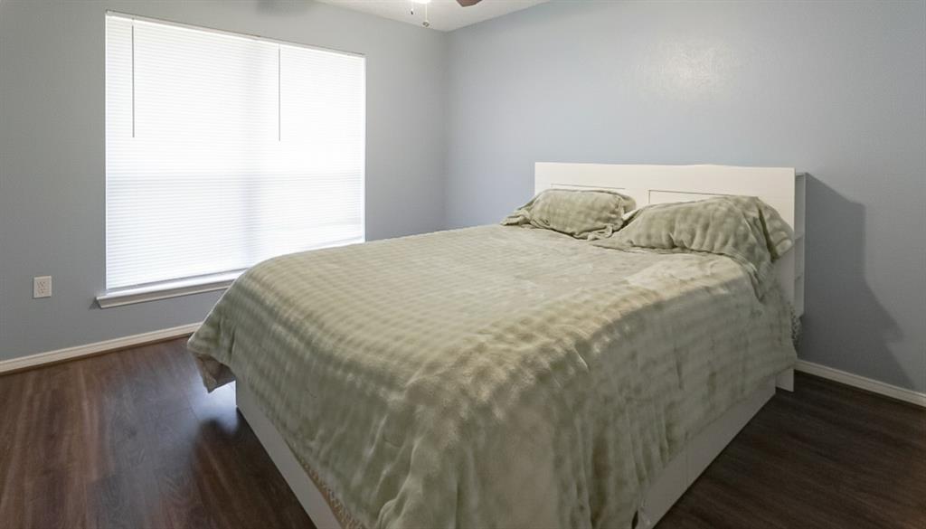 12921 Abrams Road, Unit 505 Dallas, TX 75243 - Photo 12 of 24 Bedroom with dark wood-style floors and ceiling fan