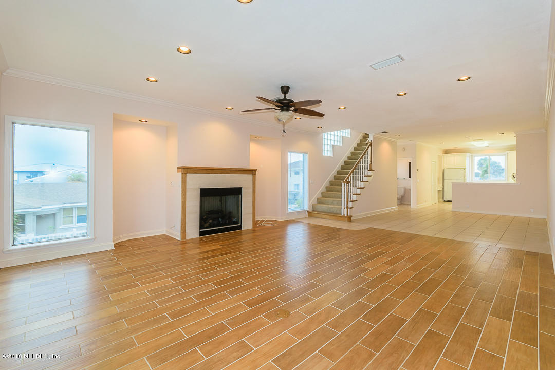 1626 Strand Street Neptune Beach, FL 32266 - Photo 12 of 51 a view of an empty room with a fireplace and wooden floor