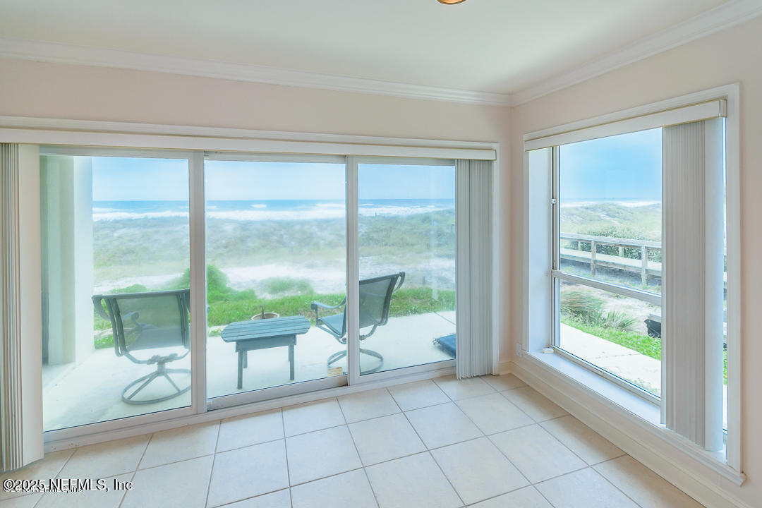 1626 Strand Street Neptune Beach, FL 32266 - Photo 35 of 51 a living room filled with furniture and a floor to ceiling window