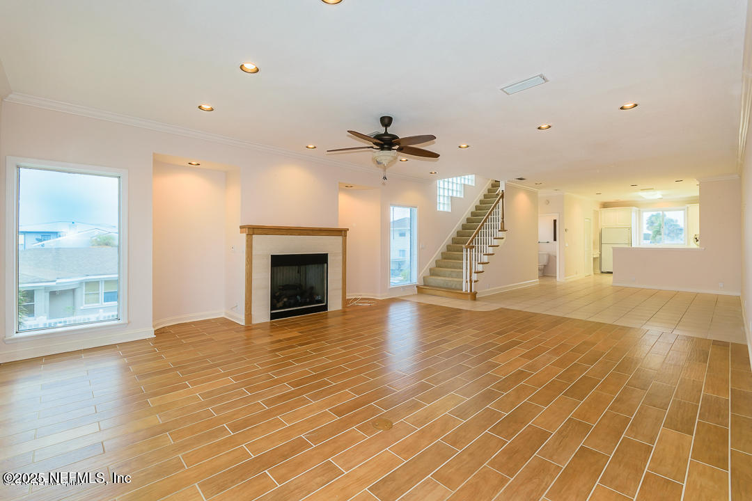 1626 Strand Street Neptune Beach, FL 32266 - Photo 40 of 51 a view of an empty room with a fireplace and wooden floor