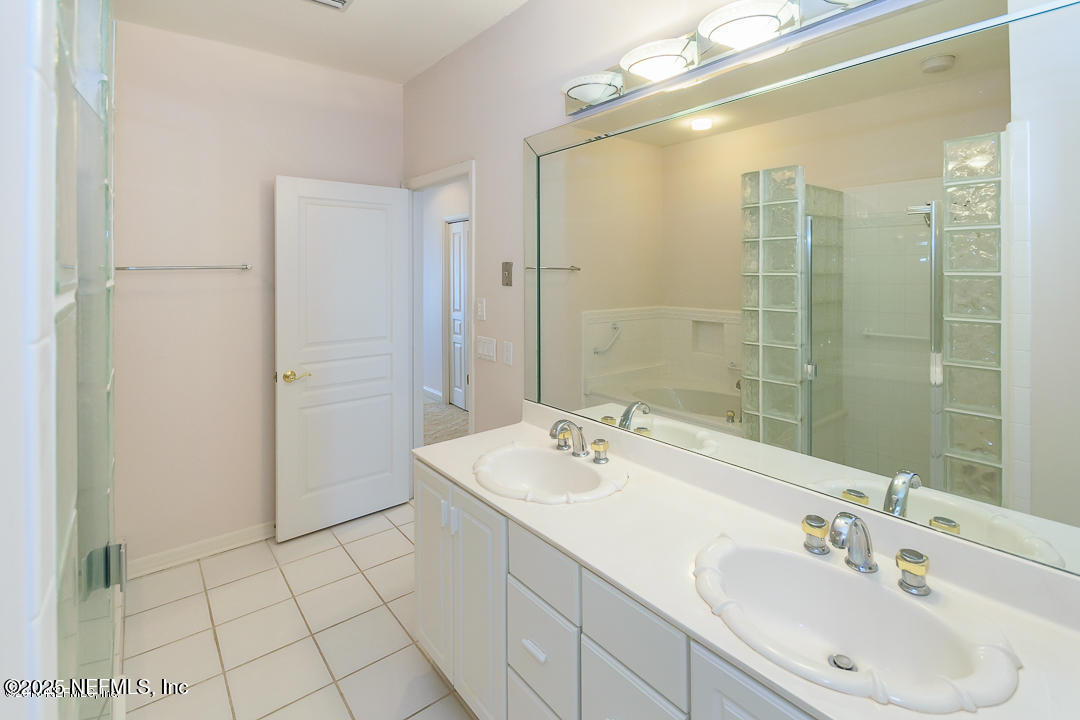 1626 Strand Street Neptune Beach, FL 32266 - Photo 44 of 51 a bathroom with a sink a shower and a mirror