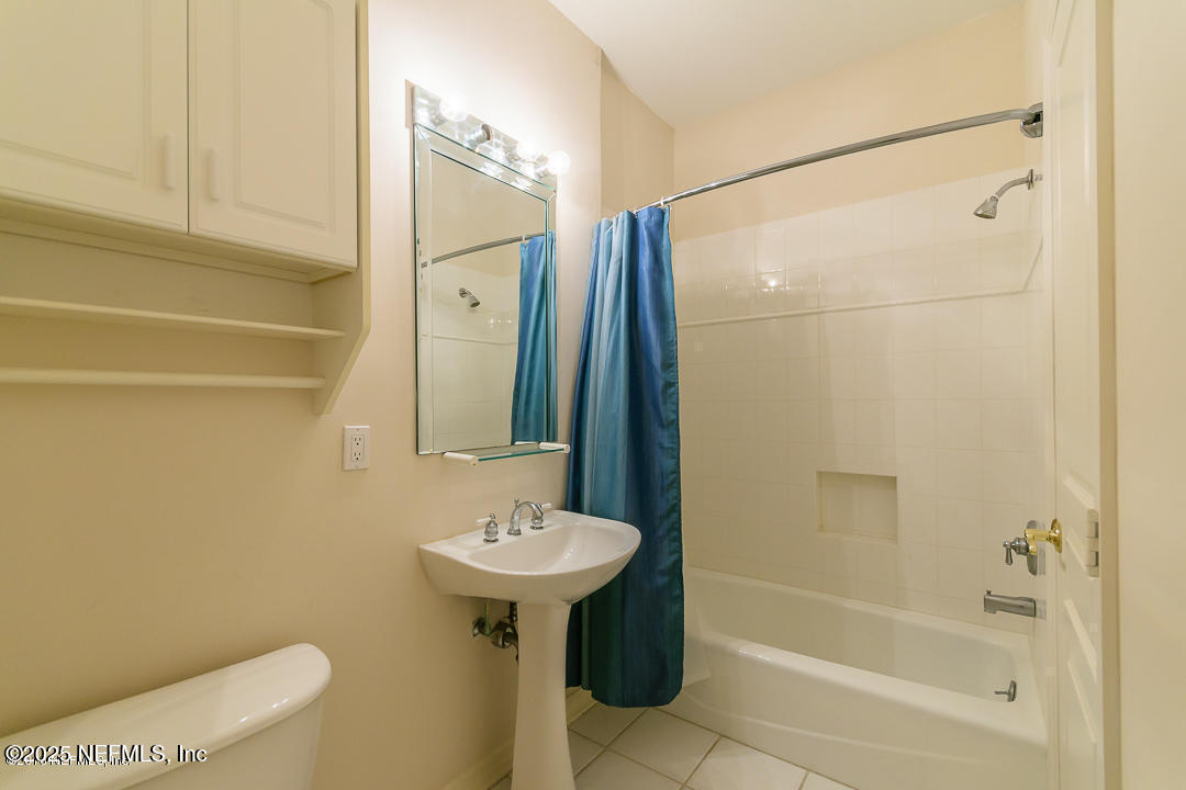 1626 Strand Street Neptune Beach, FL 32266 - Photo 48 of 51 a bathroom with a sink a mirror toilet and bathtub
