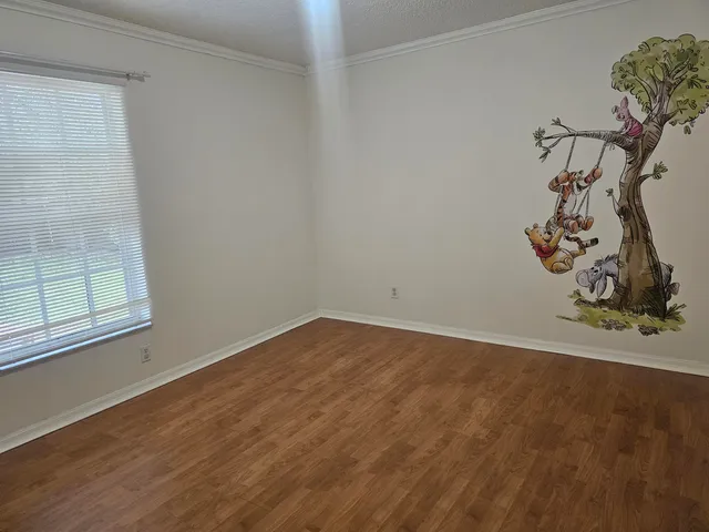 a view of wooden floor and a window in an empty room