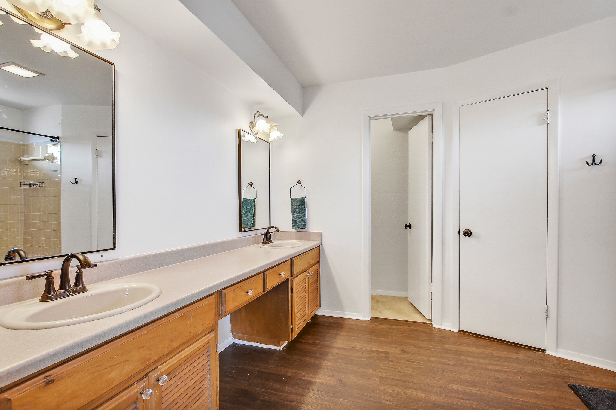 8925 North Plaza, Unit 69 Austin, TX 78753 - Photo 21 of 29 Bathroom with double vanity, dark wood finished floors, and a shower