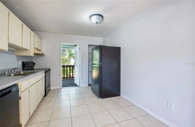 a large kitchen with a stove and a refrigerator