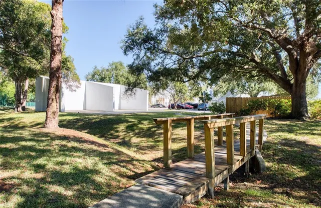 a view of a balcony with floor to ceiling window and tree