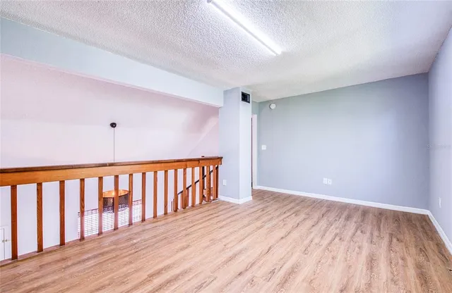 a view of hallway with wooden floor