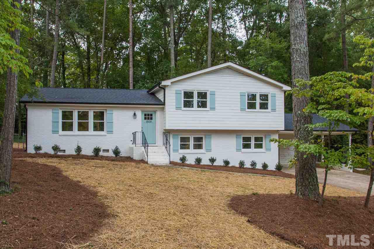 1509 Shadowood Lane Raleigh, NC 27612 - Photo 1 of 25 a front view of a house with a yard and trees