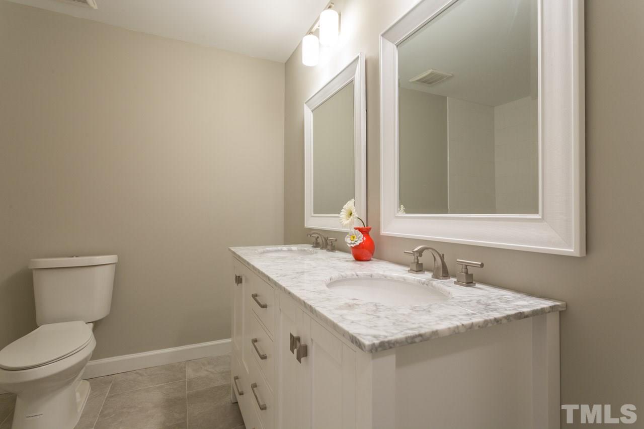 1509 Shadowood Lane Raleigh, NC 27612 - Photo 12 of 25 a bathroom with a granite countertop sink and a toilet