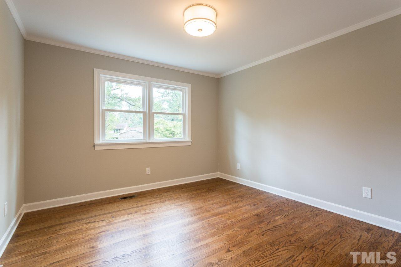 1509 Shadowood Lane Raleigh, NC 27612 - Photo 14 of 25 an empty room with wooden floor and windows