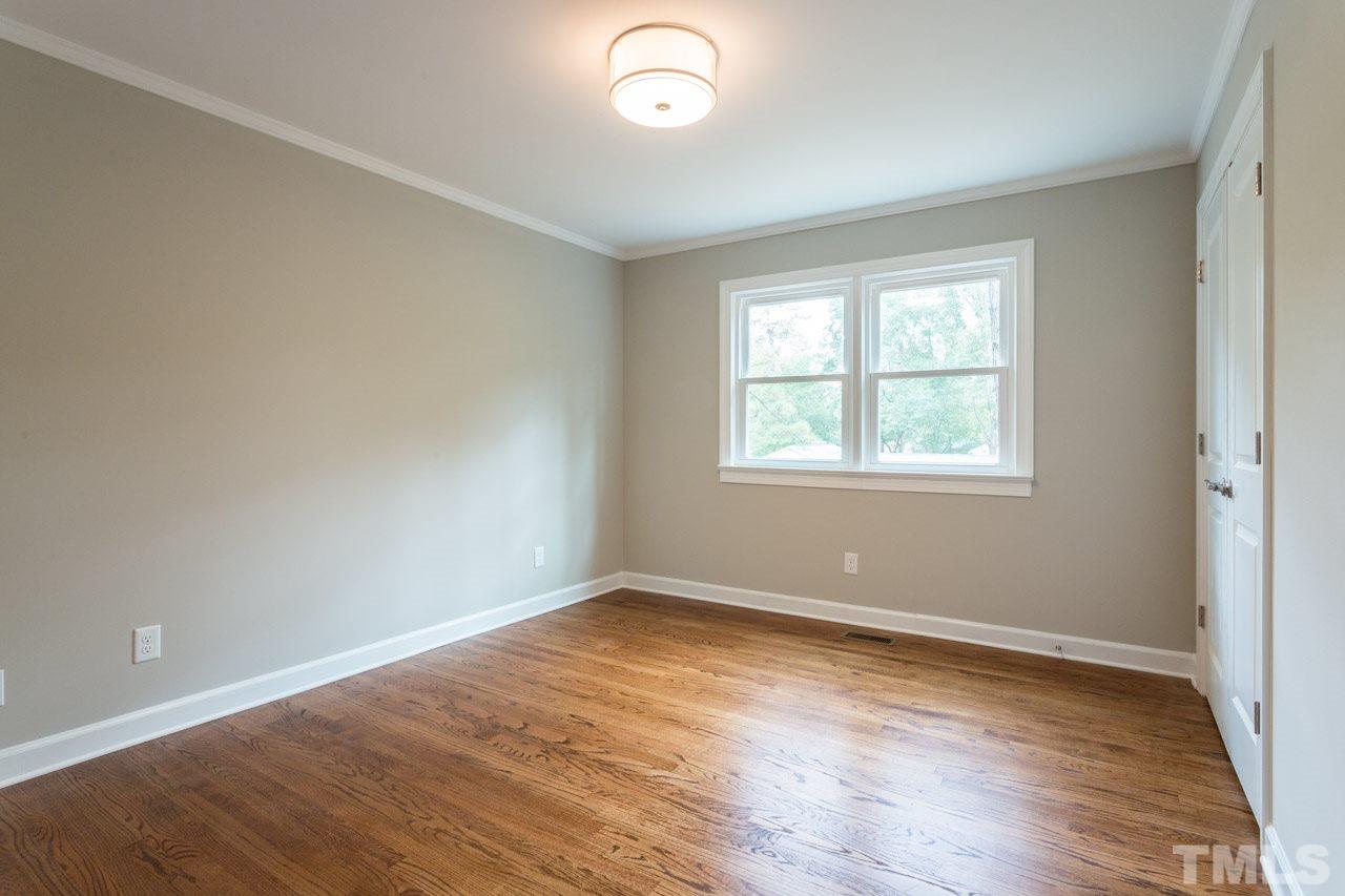 1509 Shadowood Lane Raleigh, NC 27612 - Photo 16 of 25 an empty room with wooden floor and windows