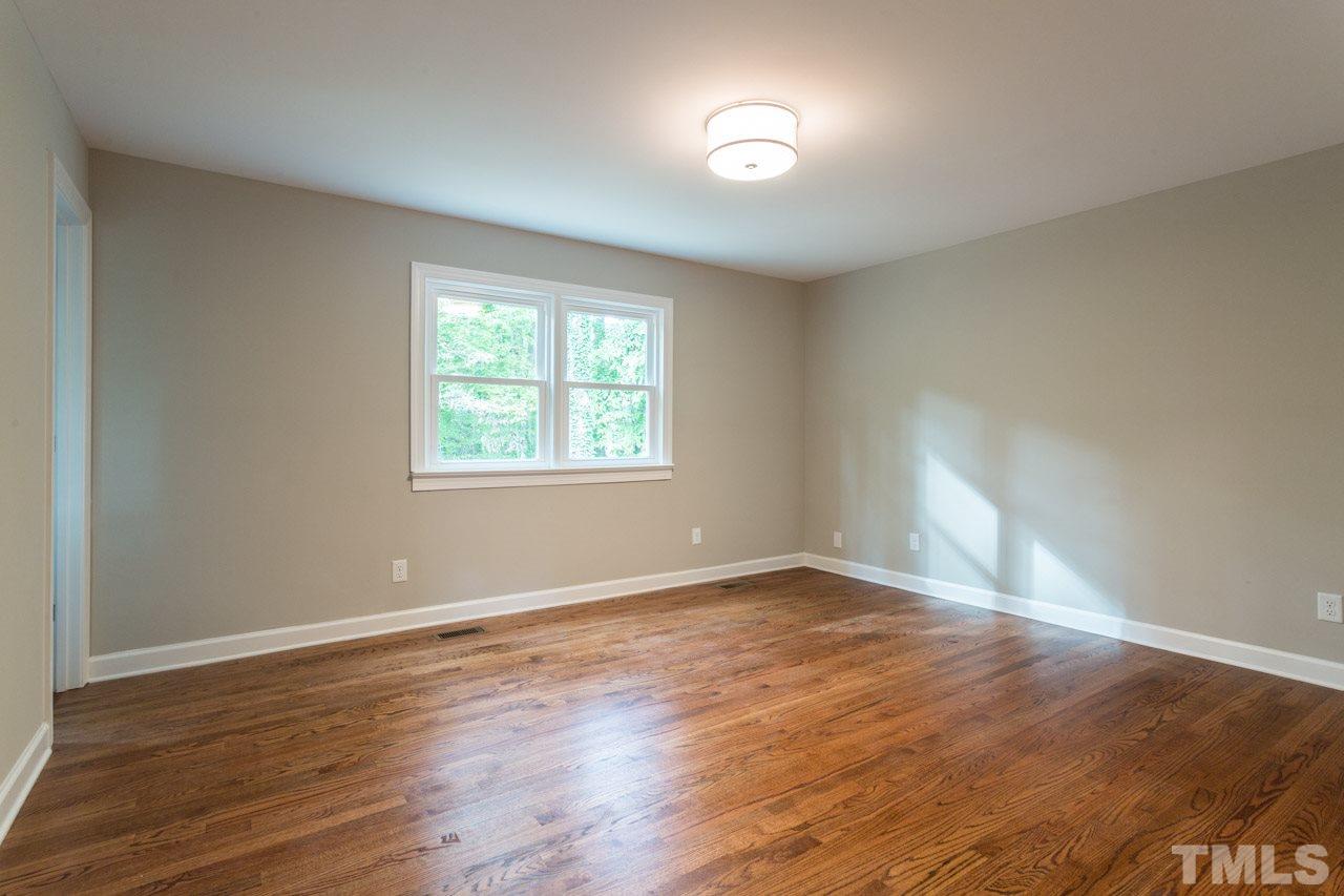 1509 Shadowood Lane Raleigh, NC 27612 - Photo 18 of 25 an empty room with wooden floor and windows