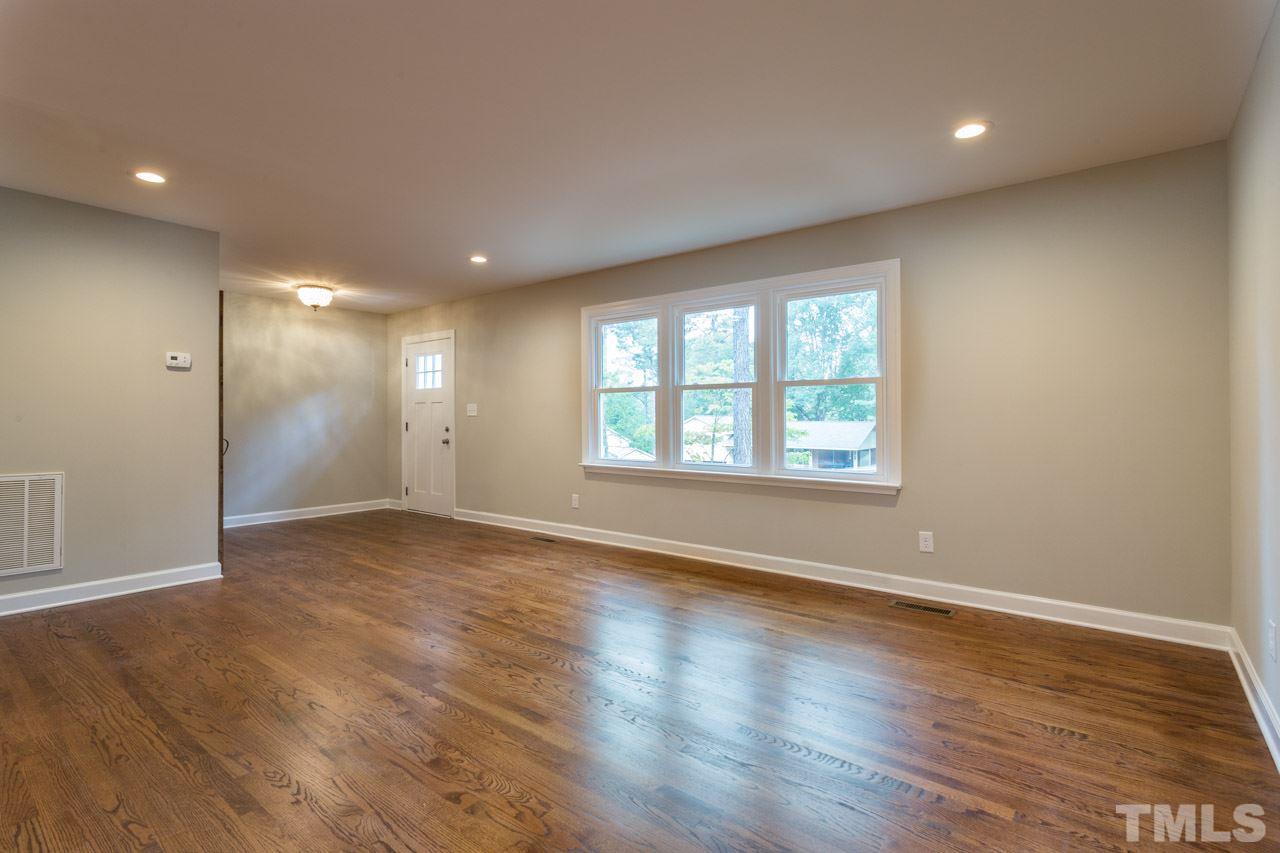 1509 Shadowood Lane Raleigh, NC 27612 - Photo 22 of 25 an empty room with wooden floor and windows