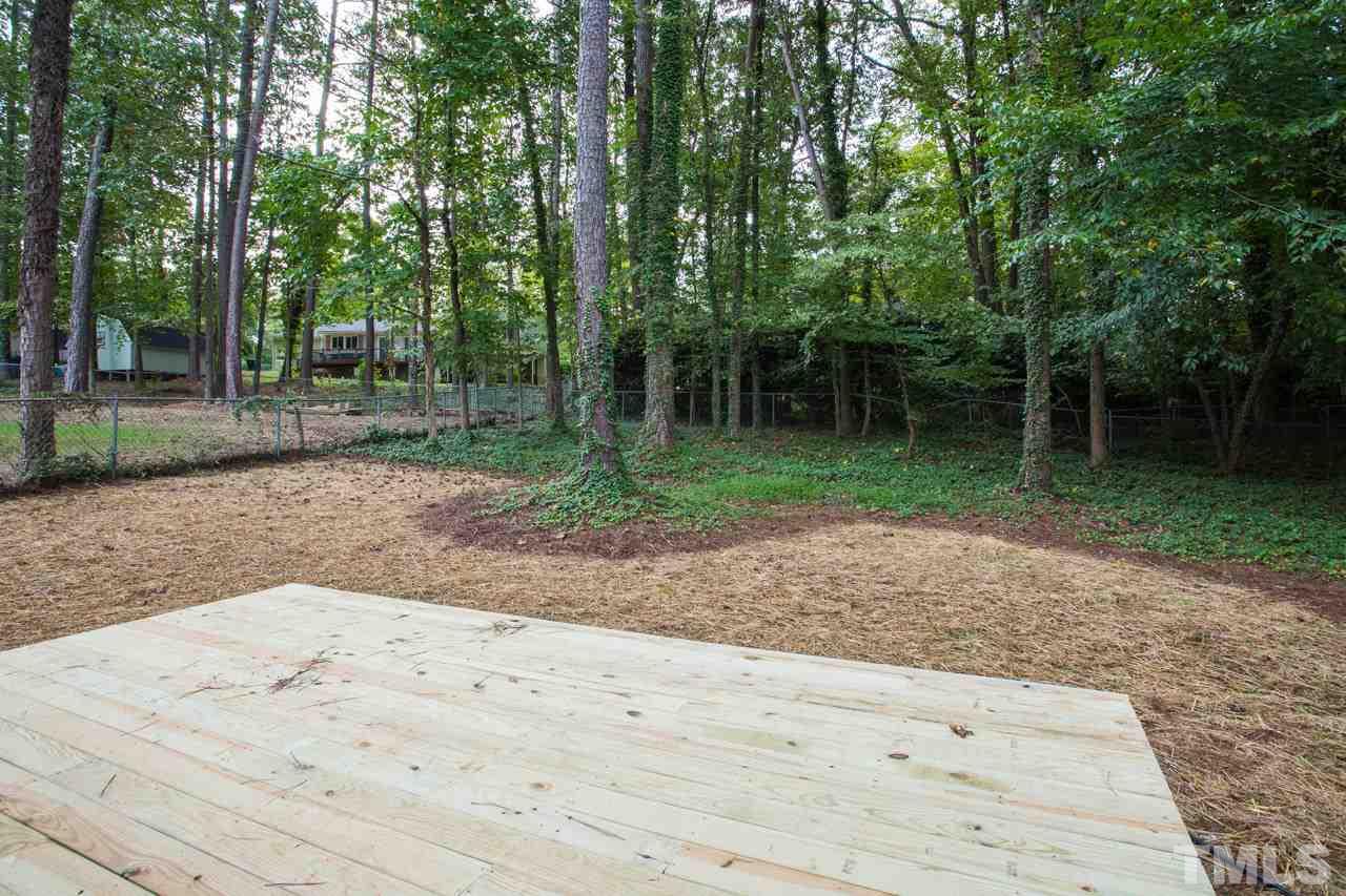 1509 Shadowood Lane Raleigh, NC 27612 - Photo 25 of 25 a backyard of a house with lots of green space