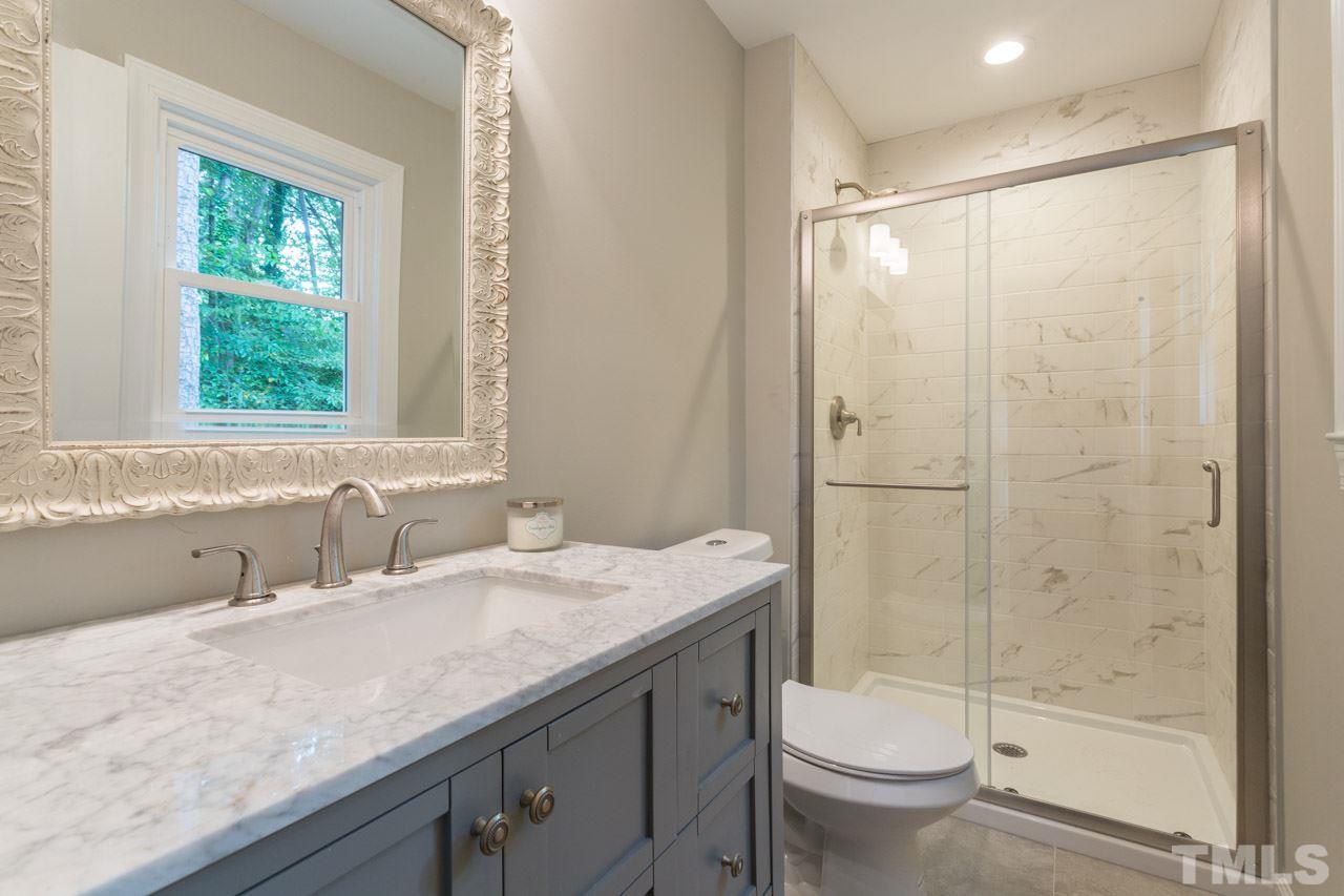1509 Shadowood Lane Raleigh, NC 27612 - Photo 4 of 25 a bathroom with a granite countertop sink toilet and shower
