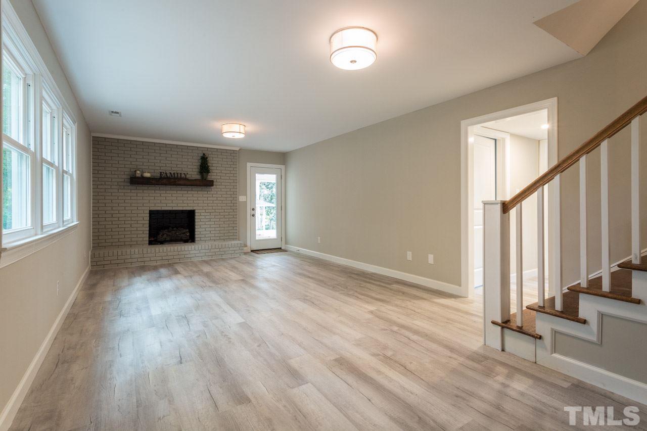 1509 Shadowood Lane Raleigh, NC 27612 - Photo 5 of 25 a view of an empty room with wooden floor and a window