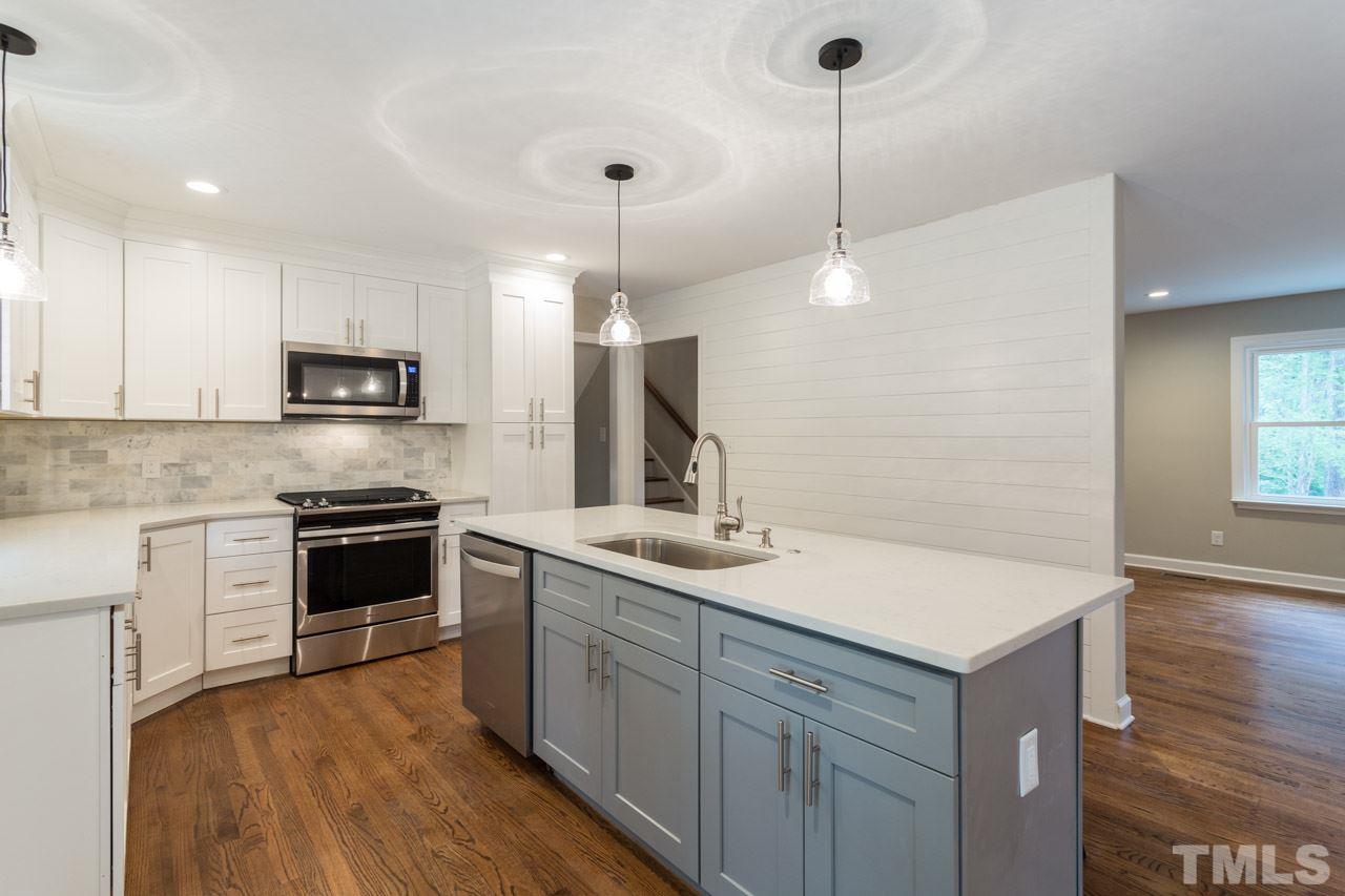 1509 Shadowood Lane Raleigh, NC 27612 - Photo 8 of 25 a kitchen with a sink and a microwave oven